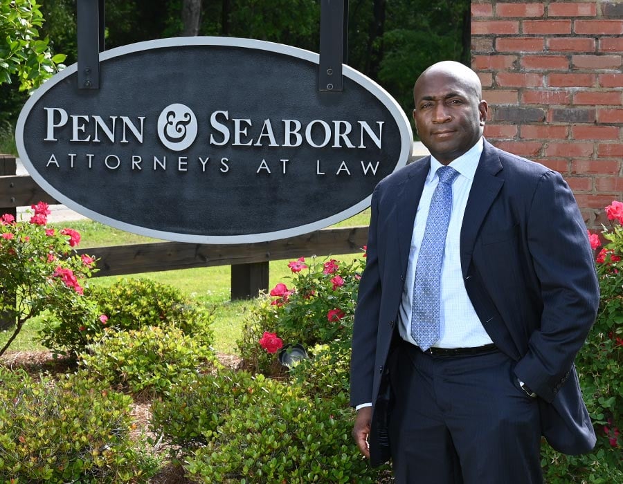 Attorney Myron Penn Standing In Front Of Penn & Seaborn Sign Outside Law Office