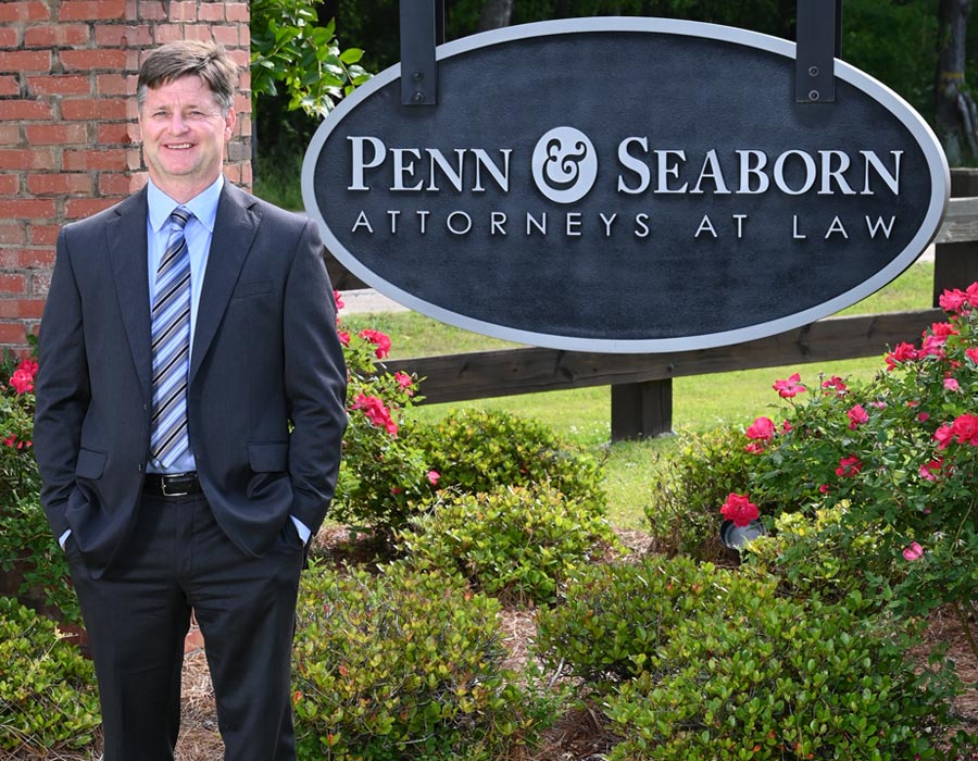 Attorney Shane Seaborn Standing In Front Of Penn & Seaborn Sign Outside Law Office